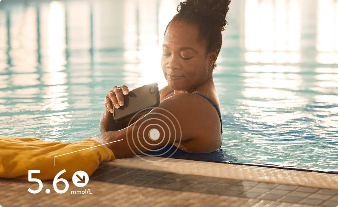 A woman monitoring her glucose level in a swimming pool