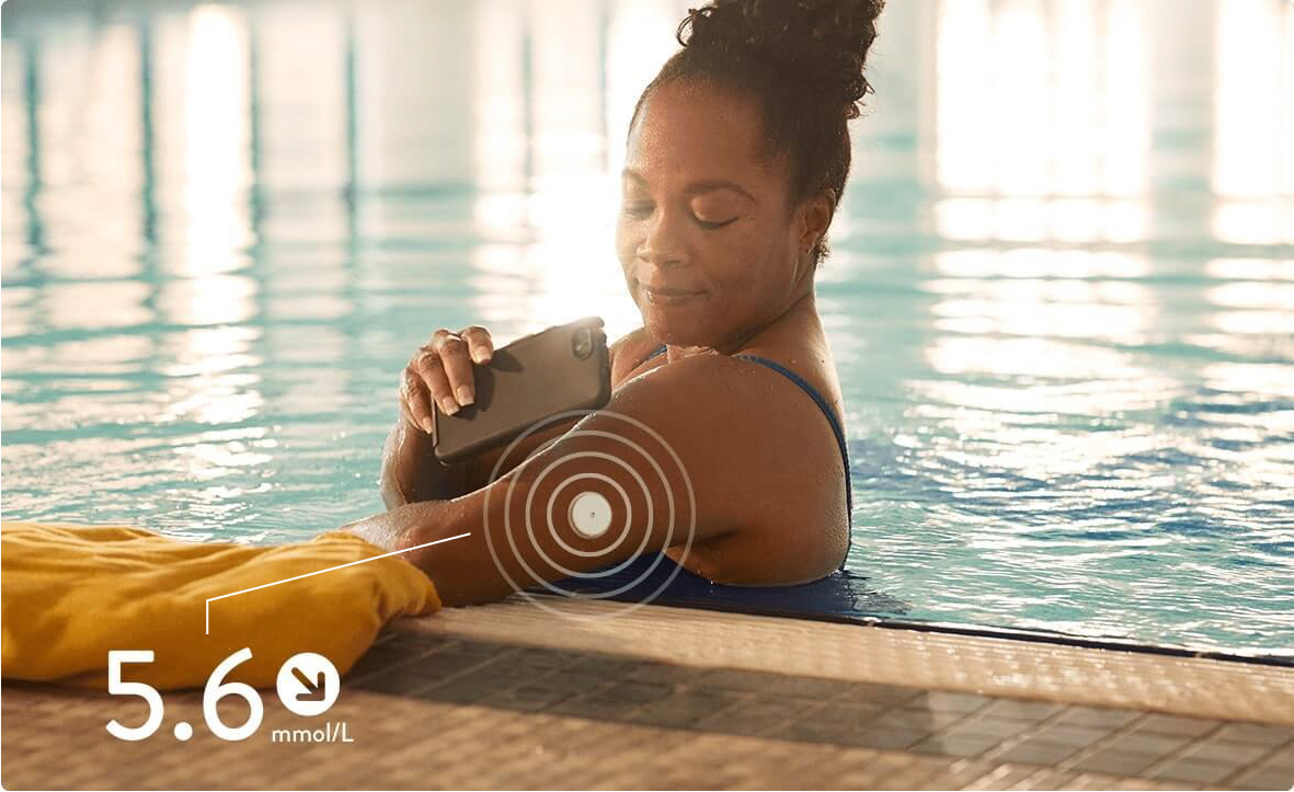 A woman monitoring her glucose level in a swimming pool